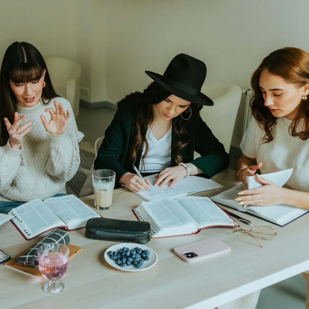 Birch & Ink — About Our Team Four colleagues discussing a project in a modern office setting.